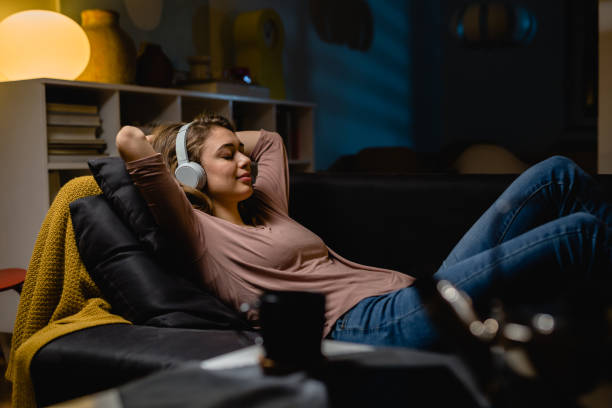 Woman relaxing at home listening to music dream house energy Dream house energy